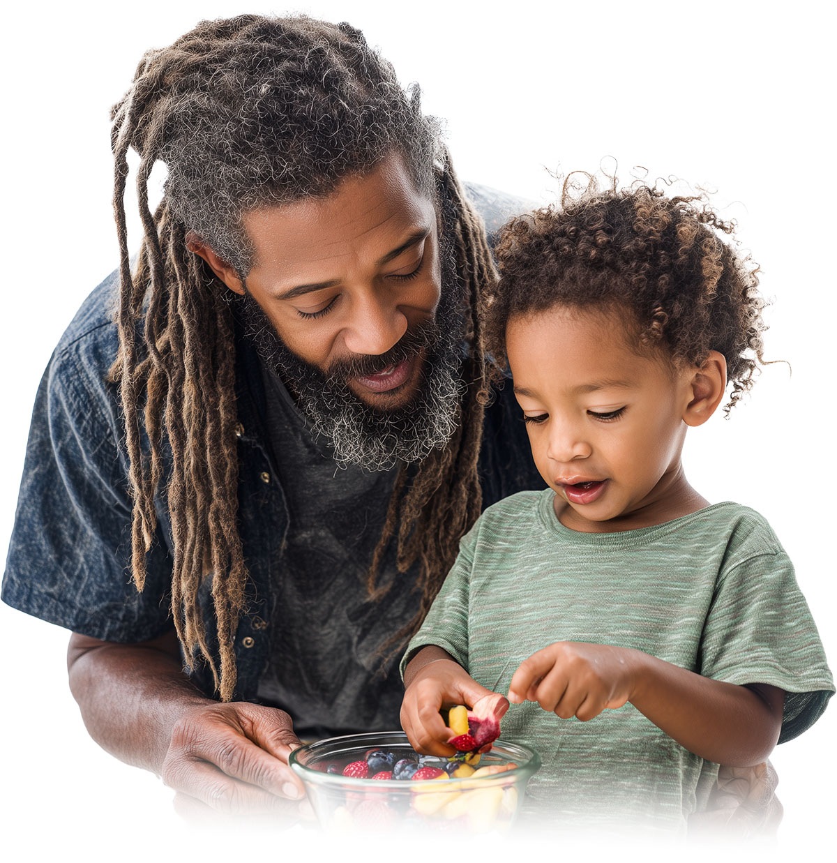 Dad fixing a bowl of fresh fruit for his child.